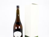 a bottle of wine next to a box on a white surface