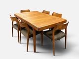 a wooden table with six chairs around it