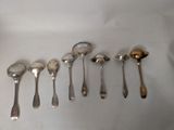 a lot of spoons that are lined up on the table