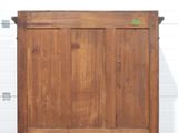 an old wooden door with a green sticker on it