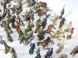 a lot of figurines that are on a white surface