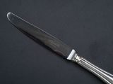 a knife that is sitting on top of a black table