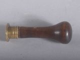 a small wooden object on a table with a white background