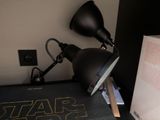 a lamp that is sitting on a desk next to a book