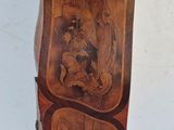 a small wooden cabinet with carvings on it