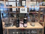 many bottles of wine on display in a glass case