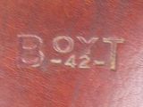 a close up of a brown leather case with writing on it