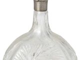 crystal decanter with a silver stopper on a white background