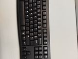 a black keyboard and mouse on a white table
