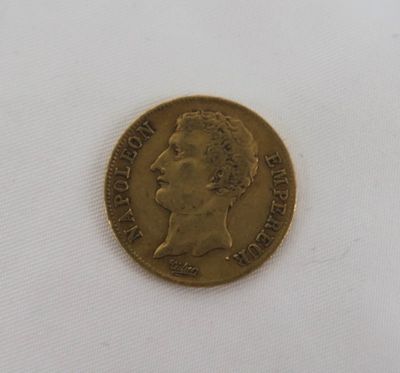 an old gold coin with a man ' s face on it