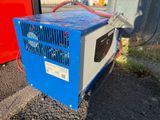 a small blue box sitting on the side of the road
