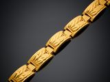 a gold bracelet on a black background