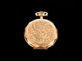 an image of a gold pocket watch on a black background