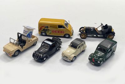 several toy cars are lined up next to each other on a white surface