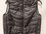 a close up of a vest hanging on a hanger