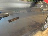 a close up of a car door with a sticker on it