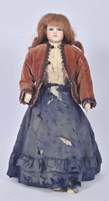 an image of a doll with red hair and a blue dress