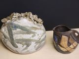 two vases sitting on a table next to each other