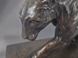 bronze sculpture of a dog on a block