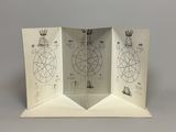 an open book with drawings on it sitting on top of a table