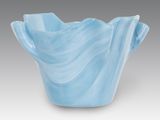 a blue vase that is sitting on a table