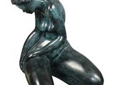 statue of a man sitting on his knees with his hands on his knees