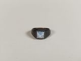 a close up of a ring with a blue stone in it