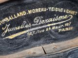 a close up of an old suitcase with a label on it