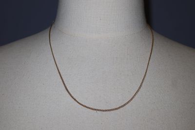 a close up of a mannequin torso with a chain on it