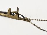 a small metal tool with a chain attached to it