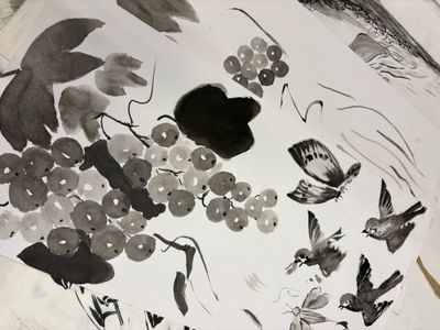 a picture of a painting of birds and flowers on a table
