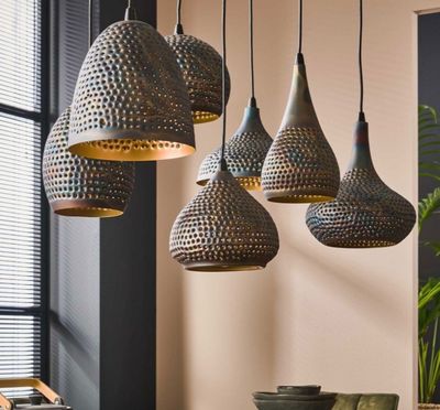 a close up of a dining room table with a bunch of lights hanging from the ceiling