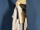 a mannequin dressed in a white dress with a black sash