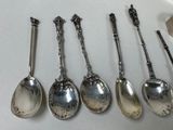 five spoons that are lined up on a table
