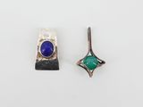 a pair of earrings with blue and green stones on them
