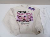 the sweater is white and has a picture of two women on it