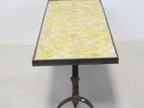 an image of a table with a yellow tile top on a metal stand