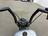 a close up of a motorcycle handlebars in a garage