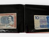 a black wallet with two different notes inside of it
