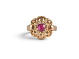 a gold ring with a pink stone in the center