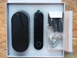 two remote controls in a box on a wooden surface