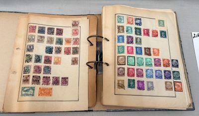 an open book with stamps on it on a table