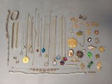 many different types of necklaces and bracelets laid out on a table