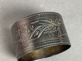 a close up of a silver ring with a bird on it