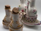 three vases and two cups on the table
