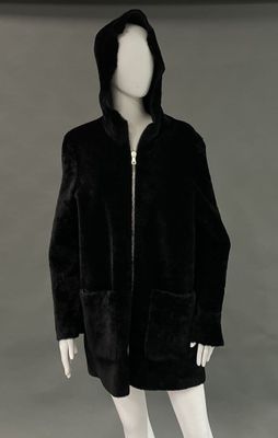 an image of a mannequin wearing a black coat with a hood