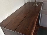 a wooden table with a lamp on top of it