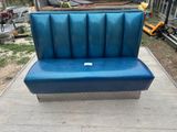 a blue bench that is sitting on the ground