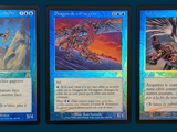 three cards with different designs are shown on a blue background