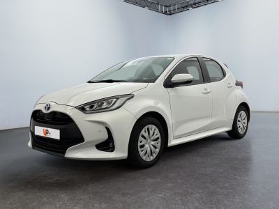 a white toyota yaris parked in a large room